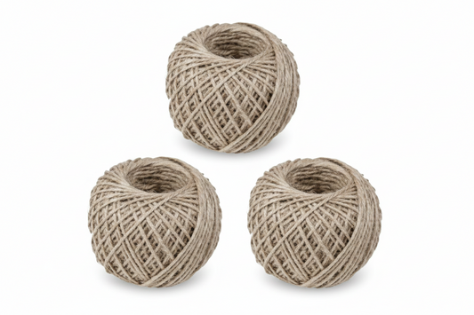 Three balls of Art Jute Gola Simple Large natural beige jute twine rope, tightly wound and displayed on white background
