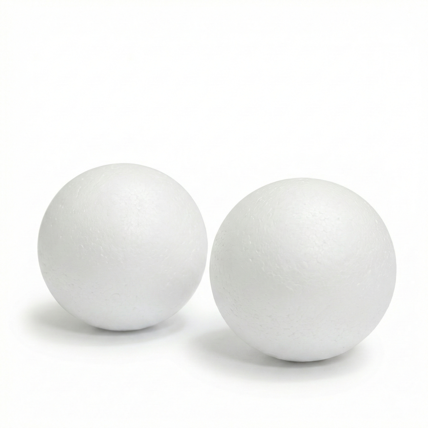 Two white polystyrene spheres (25mm thermo balls) displayed side by side on white background, showing smooth finish and round shape