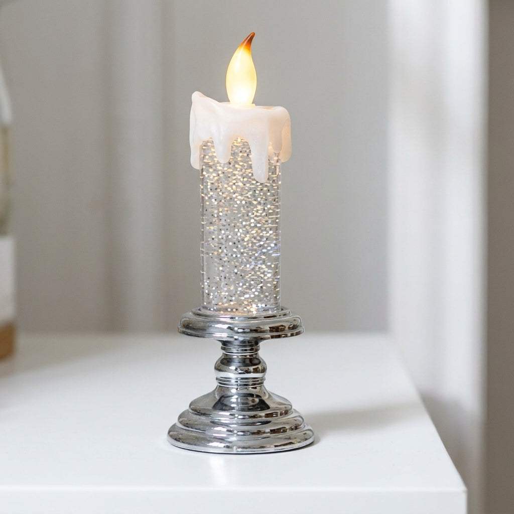 Large glitter-filled LED candle with cream wax drip top and polished chrome pedestal base