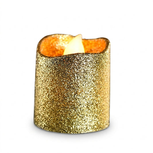 Small gold glitter candle with warm flame glowing at top, premium sparkly finish