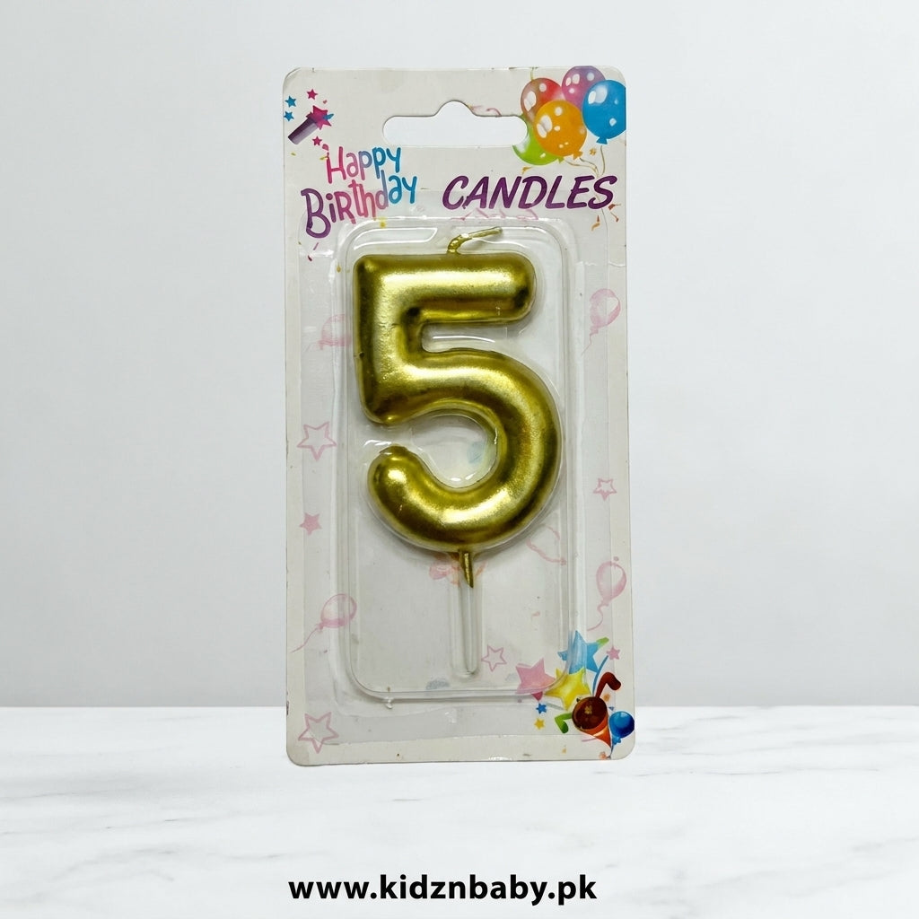 Golden number 5 birthday candle in retail packaging with colorful balloon and star designs