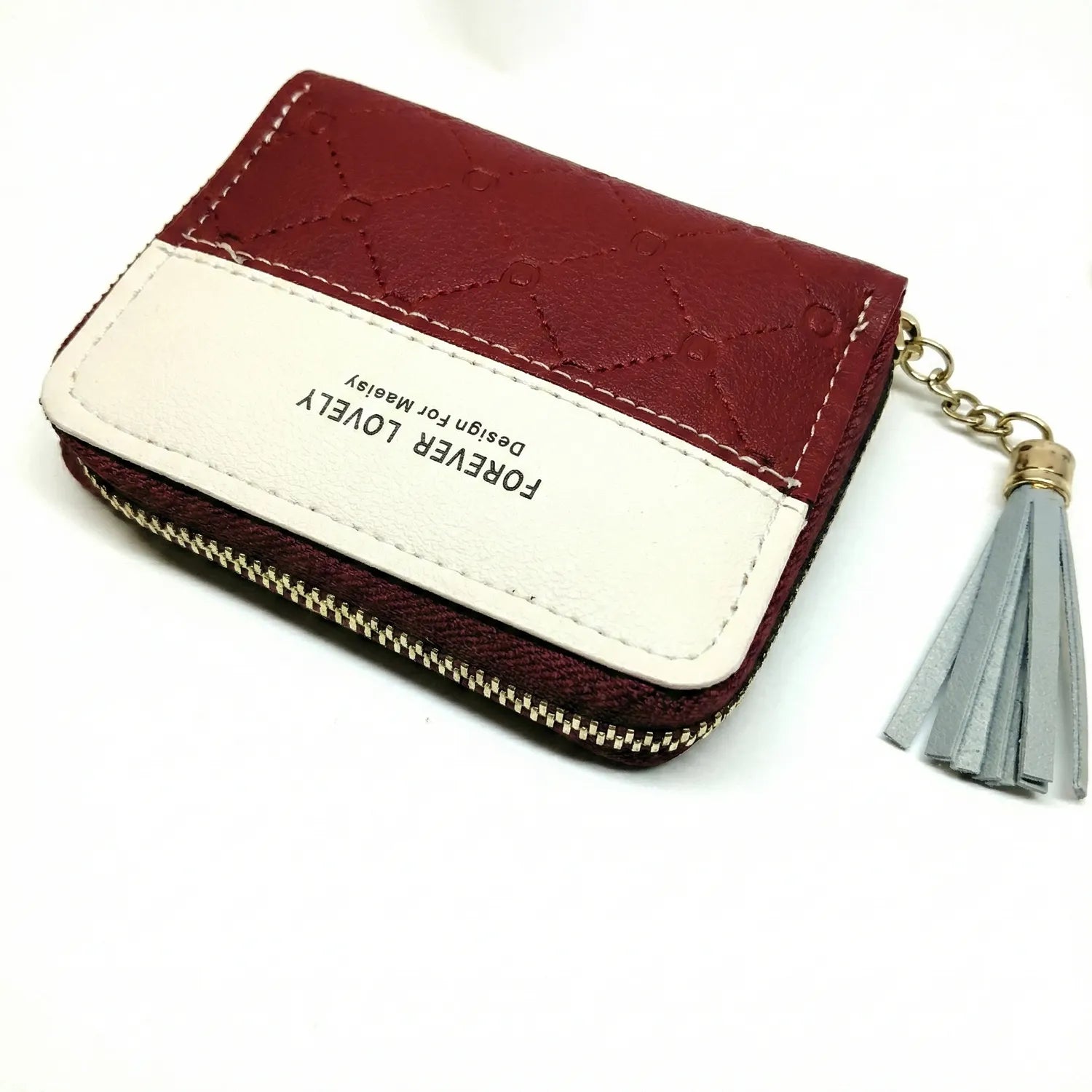 Burgundy and cream quilted leather card case zipper with gold hardware and gray tassel keychain attachment