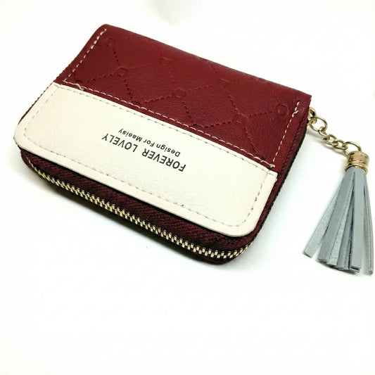 Burgundy and cream quilted leather card case zipper with gold hardware and gray tassel keychain attachment