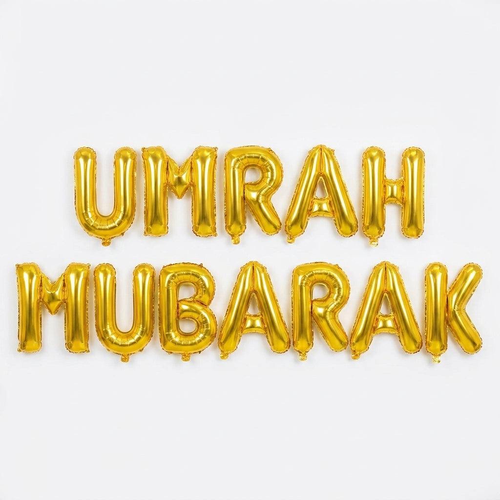Gold foil letter balloons spelling "UMRAH MUBARAK" on white background