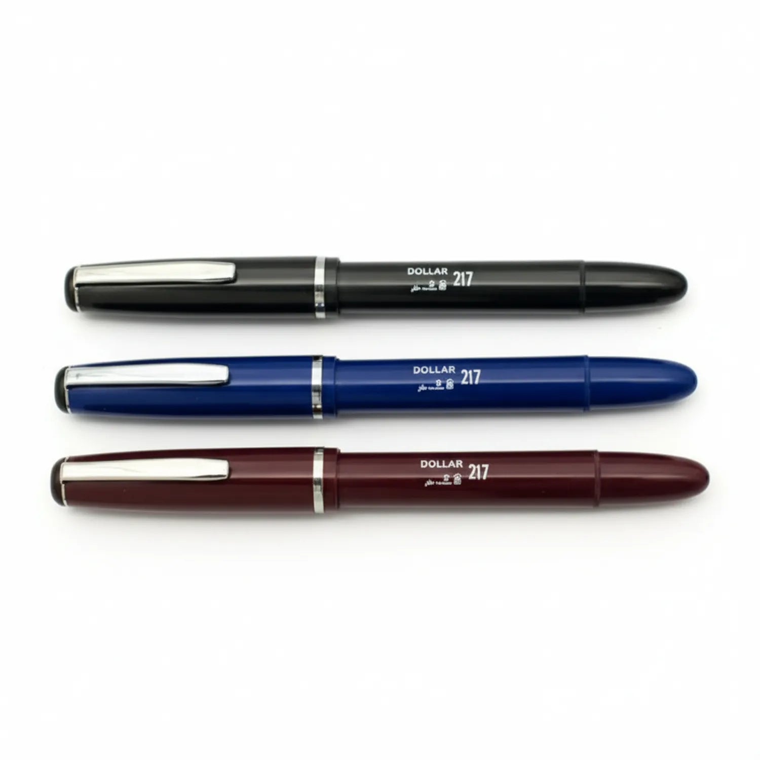 Three Dollar 217 fountain pens displayed horizontally in black, navy blue, and burgundy with chrome accents and medium nibs