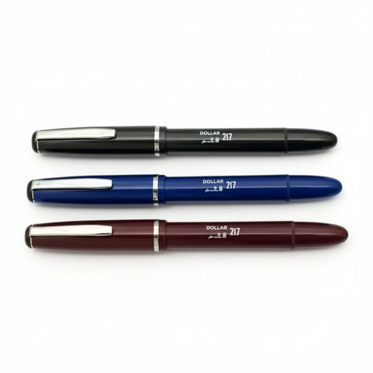 Three Dollar 217 fountain pens displayed horizontally in black, navy blue, and burgundy with chrome accents and medium nibs