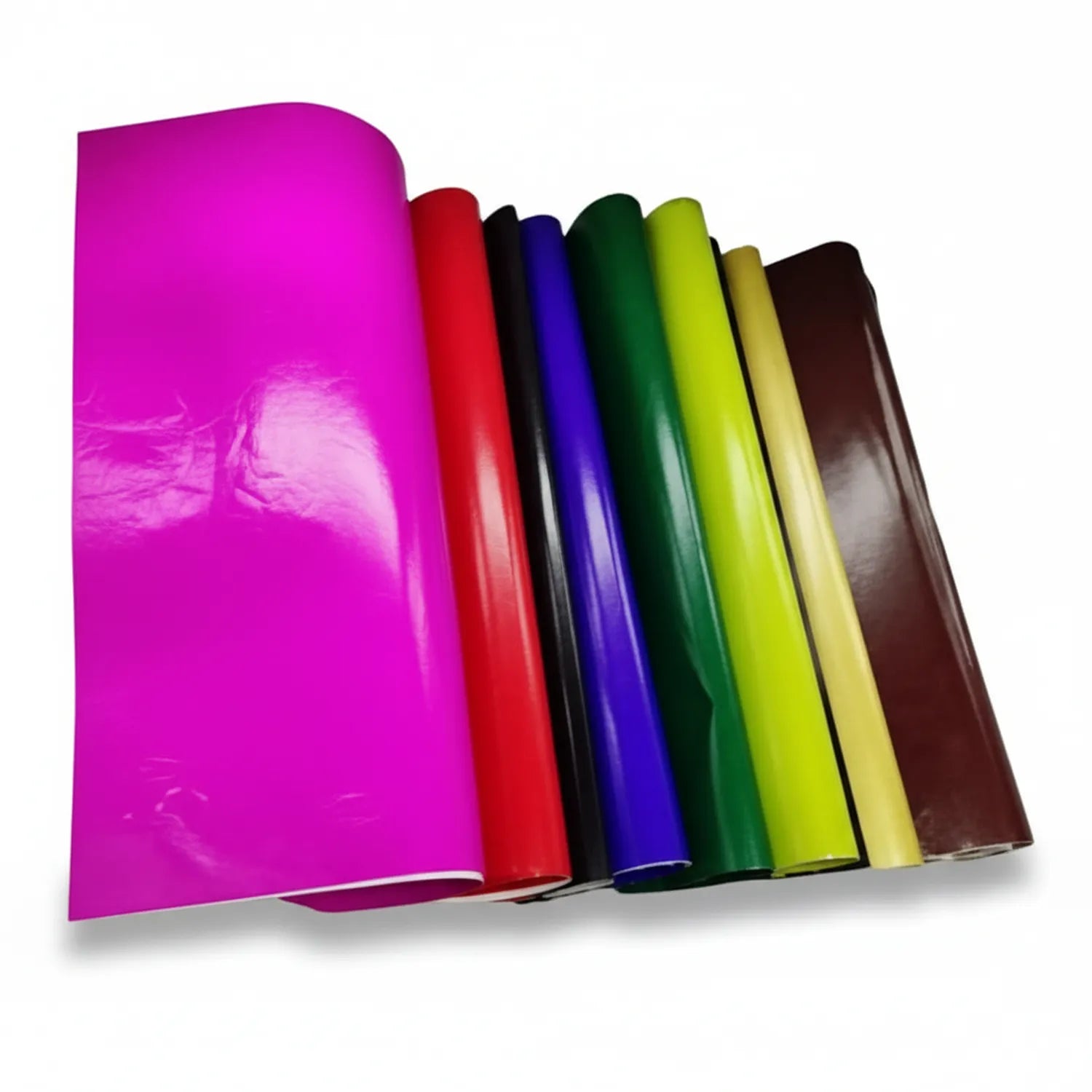 Stack of 10 colorful Glaze Paper rolls showing magenta, red, black, blue, green, yellow, cream, and brown glossy paper sheets