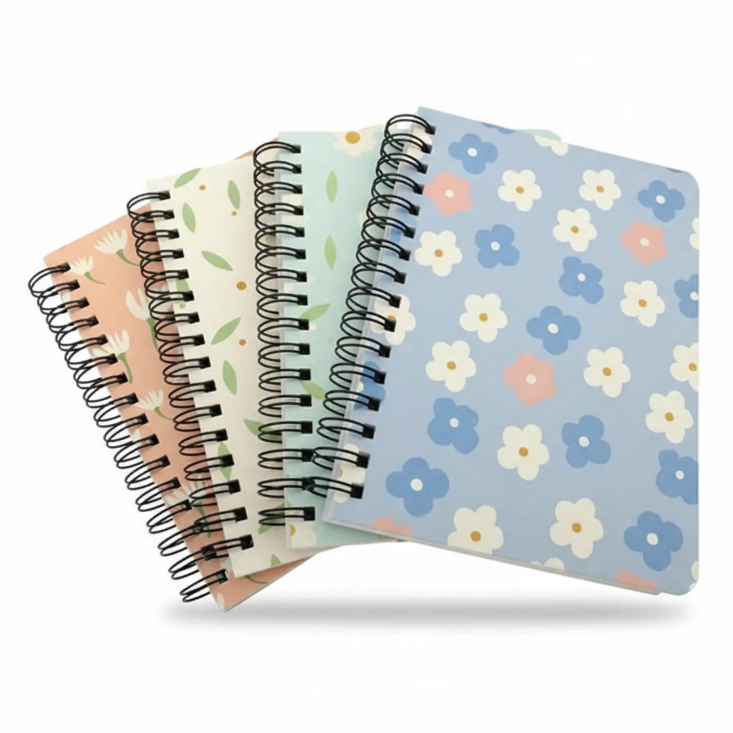 Four A6 spiral-bound journals fanned out, featuring floral designs in peach, green, cream, and blue tones with metal spiral binding