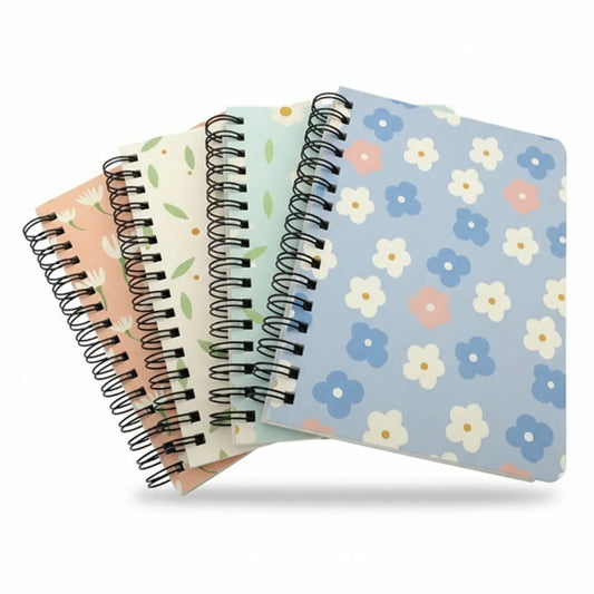 Four A6 spiral-bound journals fanned out, featuring floral designs in peach, green, cream, and blue tones with metal spiral binding