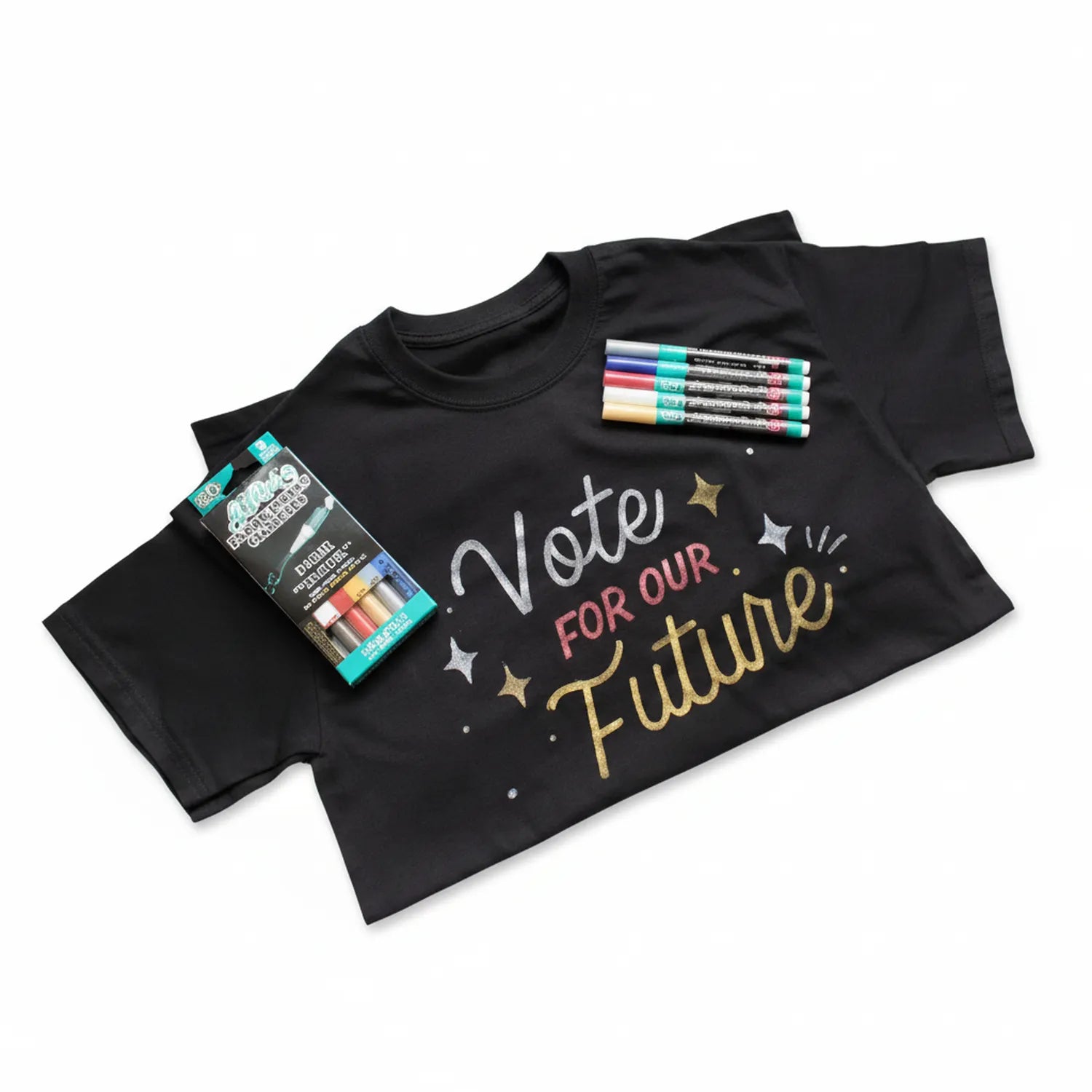 Black t-shirt with colorful metallic fabric markers and marker set package displayed. Includes white, pink, gold and blue markers for fabric design.