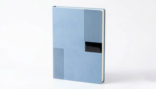 Light blue A4 hardcover notebook with ribbed texture and black label, 25 sheets, shown at angle