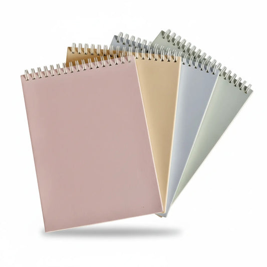 Four spiral-bound A5 note pads with 120 pages each, displayed in pastel pink, cream, blue, and sage green colors.