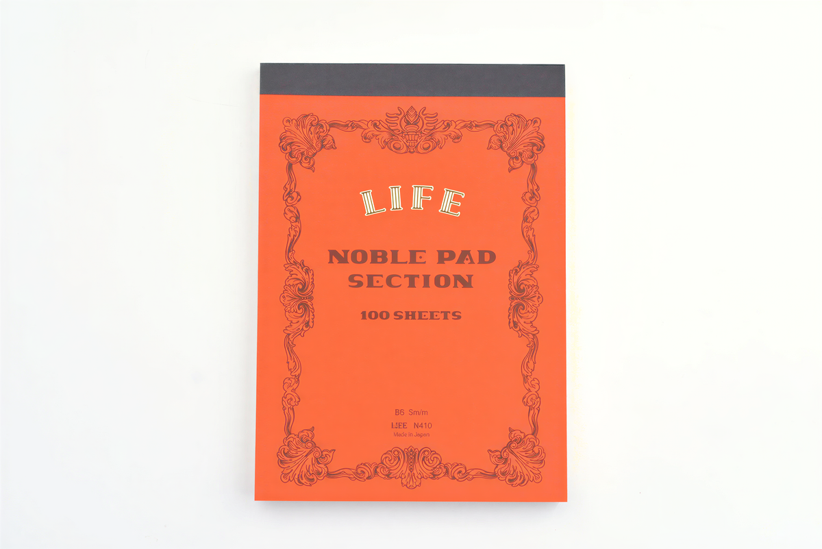Life Noble Pad Section B6 100 sheets notepad with orange cover and decorative borders