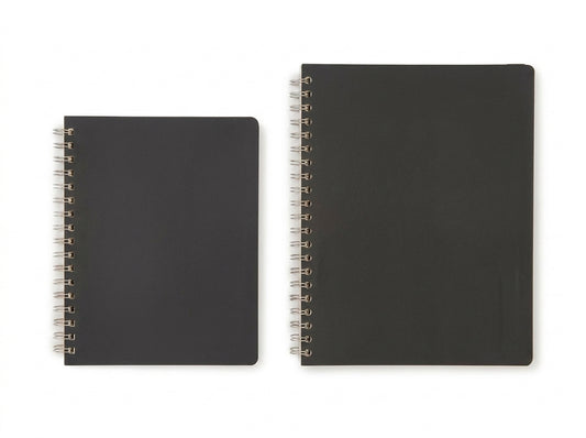 Two black spiral-bound notebooks with metal rings shown side by side against white background