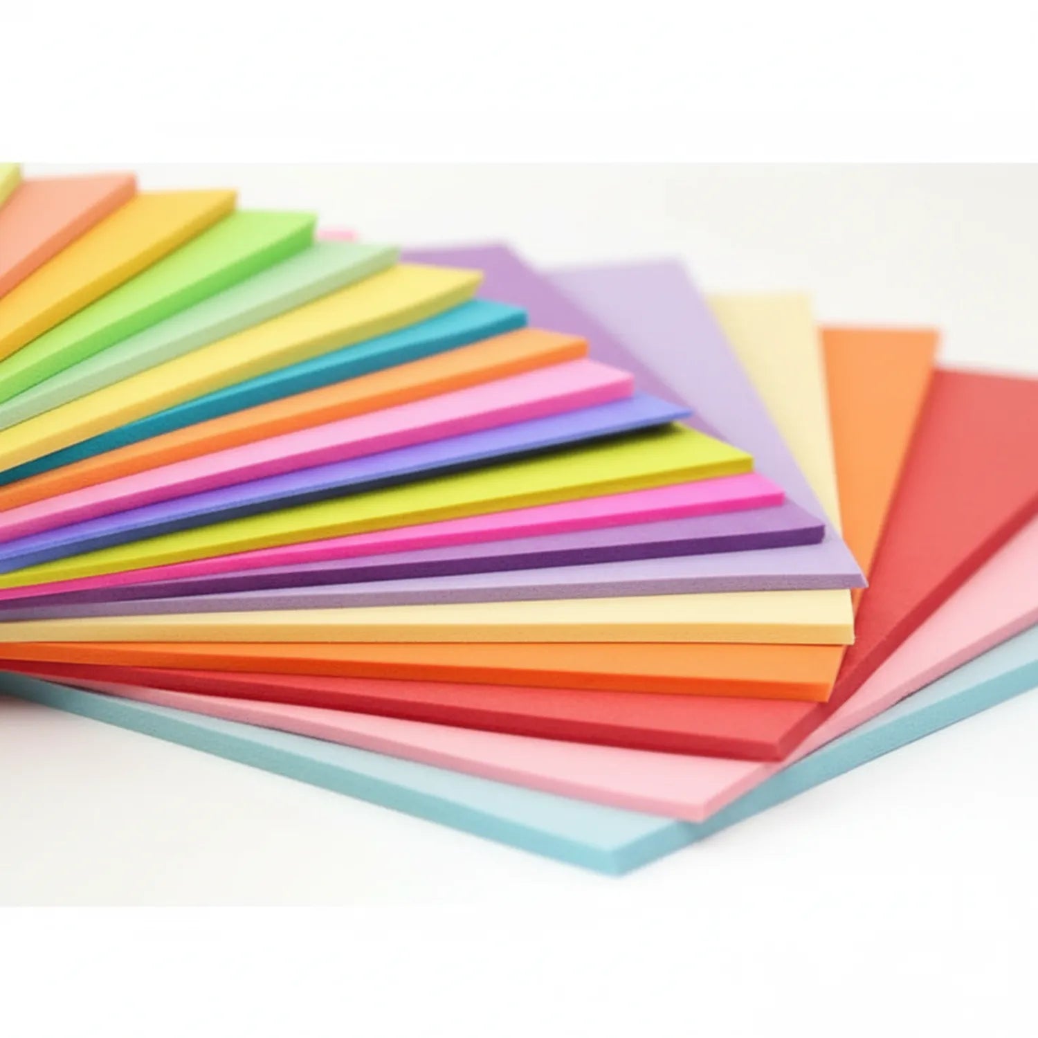 Stack of colorful A4 paper sheets fanned out displaying 20+ bright colors including yellow, pink, orange, green, blue, and purple.