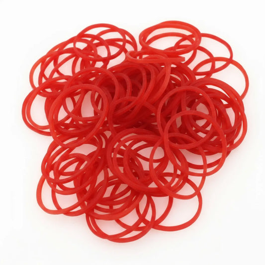 Rubber Band 001 - bundle of 50+ red elastic rubber bands in assorted sizes arranged in a clustered pile against white background