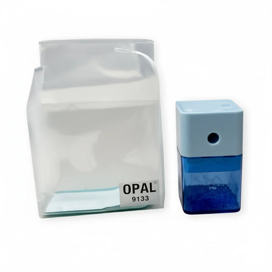 Opal 9133 pencil sharpener with white casing and integrated catch tray, displayed with blue colored pencil for scale