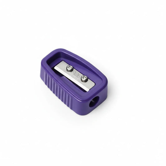 Purple Wizz W502 single-hole pencil sharpener with stainless steel blade and waste chamber visible from above