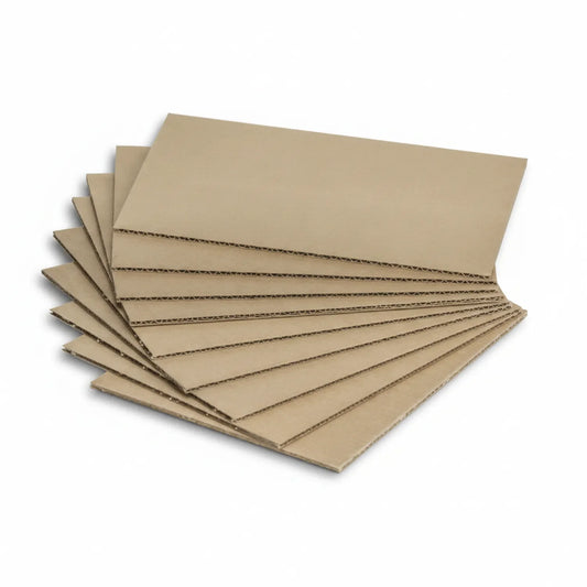 10 sheets of tan corrugated cardboard stacked in a fan arrangement, showing visible corrugated layer edges
