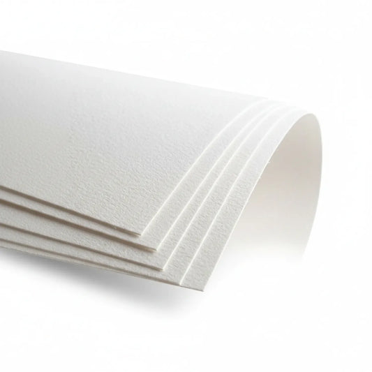 Stack of premium white watercolor paper sheets fanned out, showing cold-pressed texture and multiple layered sheets with clean edges