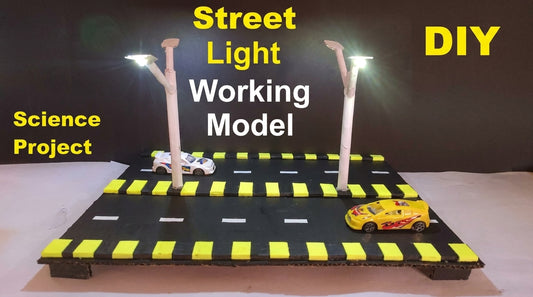 Street Light Working Model with two LED poles on black diorama base with yellow crosswalk markings and toy cars