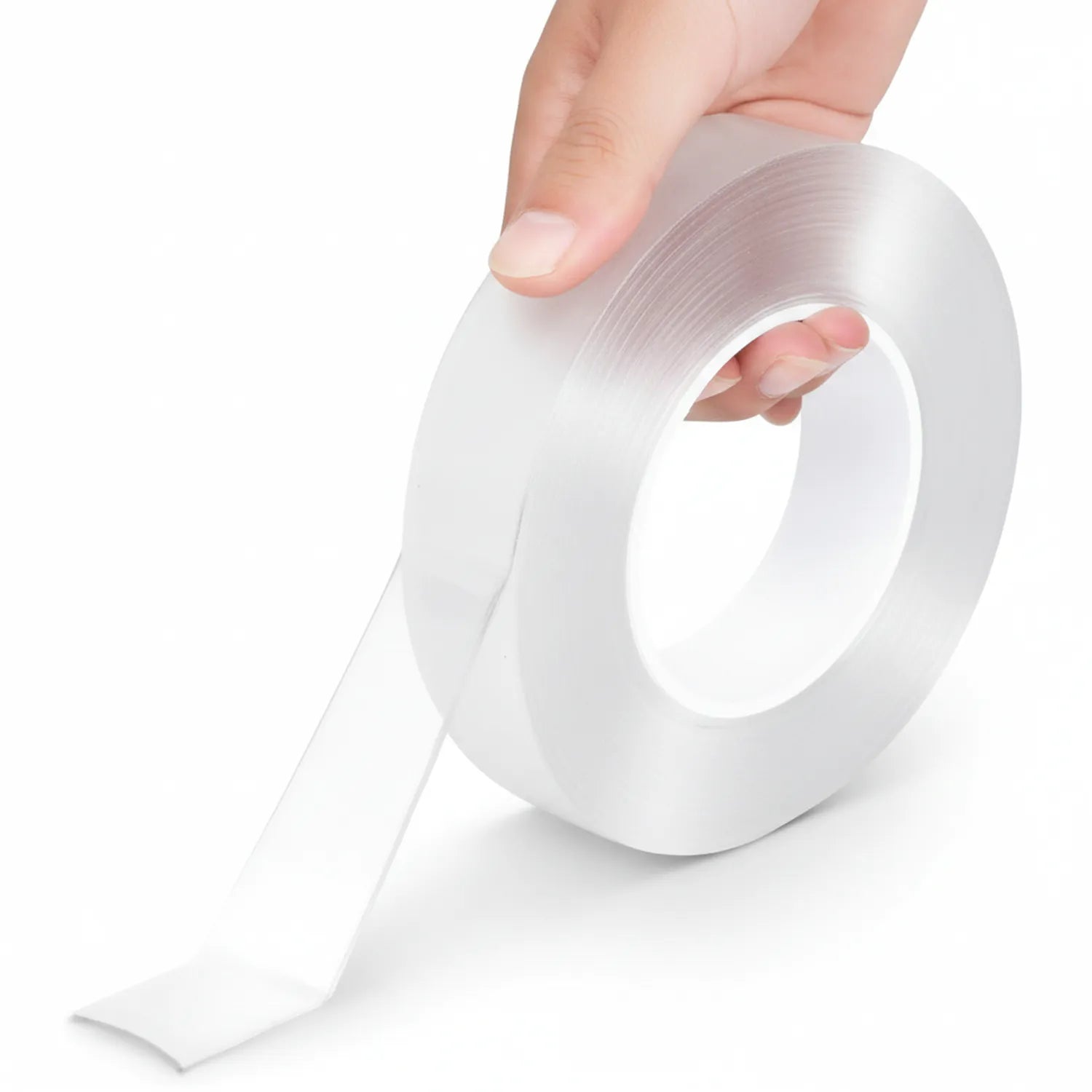 Tape Nano Opal transparent double-sided adhesive roll being unrolled by hand, showing clear tape dispensed from white cardboard core.