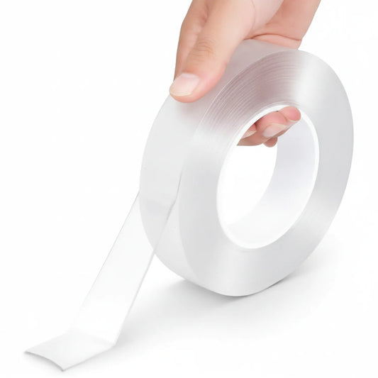 Tape Nano Opal transparent double-sided adhesive roll being unrolled by hand, showing clear tape dispensed from white cardboard core.